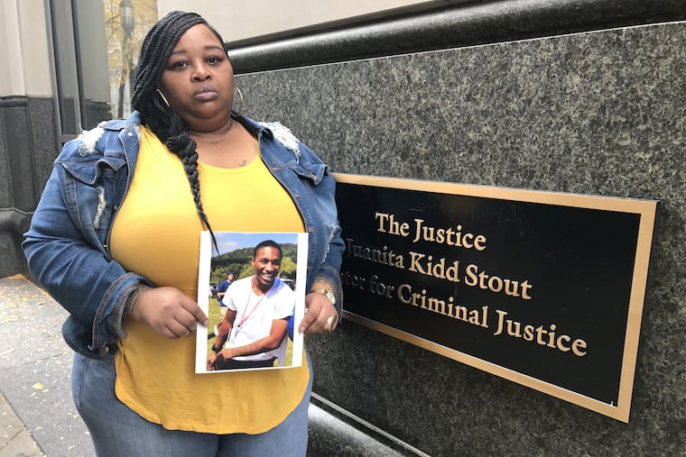 On Friday, Oct. 25, 2019, Melva Pack holds a photo of her son, Antwan Pack, who was 20 when he was fatally shot by Robert Shabazz-Davis, then 16, on the 1700 block of Ridge Avenue on Memorial Day 2012. Shabazz-Davis was resentenced Friday at the Stout Center for Criminal Justice in Philadelphia.