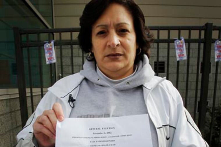 Mayra Acevedo of the Hunting Park section of Philadelphia holds up a sheet of paper containing numbers that according to poll workers are help for her and her situation. According to Mayra she registered to vote before the deadline but was not on the list. She was not given or offered a provisional ballot. Picture taken outside the Esperanza Health Center at 6th and Cayuga. This is the 43rd Ward, 3 and 6 district. Photo taken on Tuesday, November 6, 2012. (Alejandro A. Alvarez/Staff)