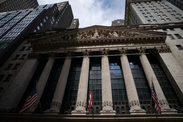 Statues adorn the facade of the New York Stock Exchange in July in New York.