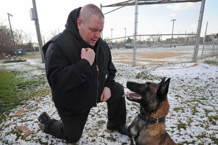 Sgt. Eugene Mackey and his dog Sarge in Folcroft, PA on Jan. 22, 2013. APRIL SAUL / Staff Photographer