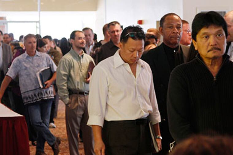 Job seekers wait in line to attend a career fair put on by National CareerFairs in San Jose on March 30. (AP Photo / Eric Risberg)