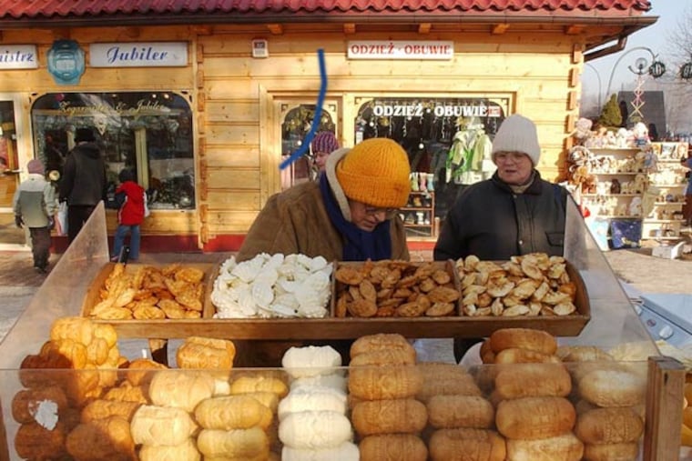 This is a Jan. 14, 2006 file photo of a street vendor selling regional smoked cheese 'oscypek ' in Zakopane, Poland. Little Miss Muffet could have been separating her curds and whey from the sixth millennium B.C., according to a new study that finds the earliest solid evidence of cheese-making. Scientists performed a chemical analysis on fragments from 34 pottery sieves discovered in Poland to determine what they were used for. Until now, experts weren't sure whether such sieves were used to make cheese, beer or honey. (AP Photo/Czarek Sokolowski, File)