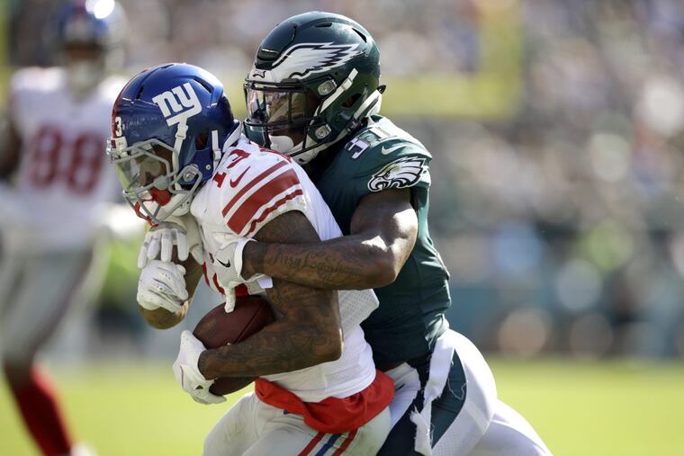 Eagles cornerback Jalen Mills (right) tackles New York Giants receiver Odell Beckham Jr. last Sunday.