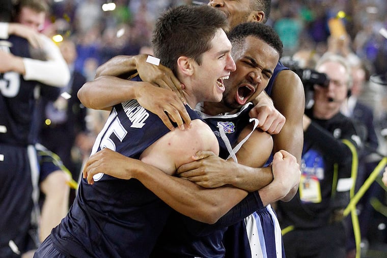 Villanova's Ryan Arcidiacono celebrates his teams win with Phil Booth
and Mikal Bridges.