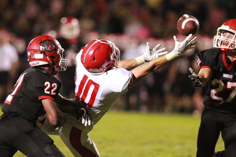 Danny Kondras (center) of Rancocas Valley stretches for the ball in a game against Lenape in October. Jo Kellum (left) and Jake Topolski are on defense.