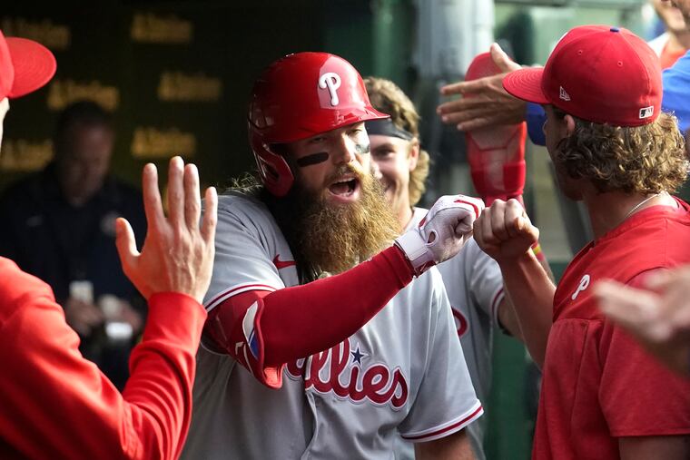 Brandon Marsh is congratulated in the dugout after his second home run of the night, a two-run shot off Chicago Cubs starting pitcher Jameson Taillon, during the fifth inning of a baseball game Tuesday, June 27, 2023, in Chicago.