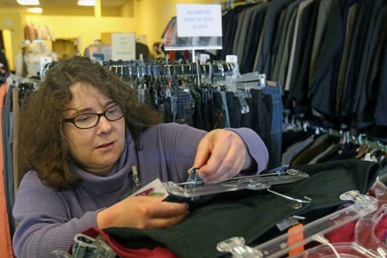 Robin Michaelson sorts through donations at the Jewish Family & Children's Services store in Northeast Philly.