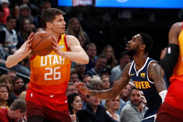 Utah Jazz guard Kyle Korver, left, looks to pass the ball as Denver Nuggets guard Will Barton defends during the first half of an NBA basketball game Thursday, Feb. 28, 2019, in Denver. (AP Photo/David Zalubowski)