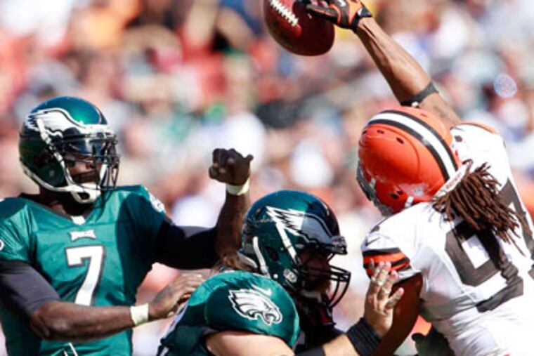 Michael Vick, who threw four picks against the Browns, had this pass deflected. (Yong Kim/Staff photographer)