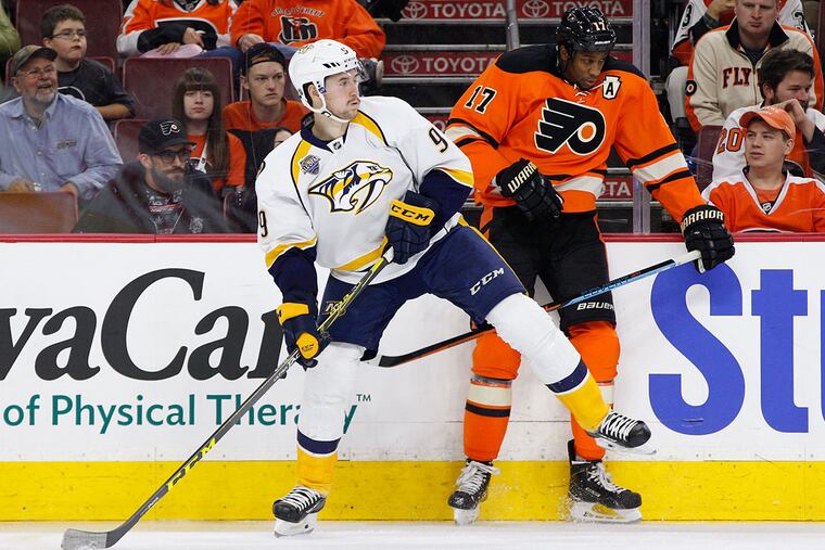 The Flyers' Wayne Simmonds (right) and Nashville's Filip Forsberg battle along the boards during the third period Friday. (Chris Szagola / AP)