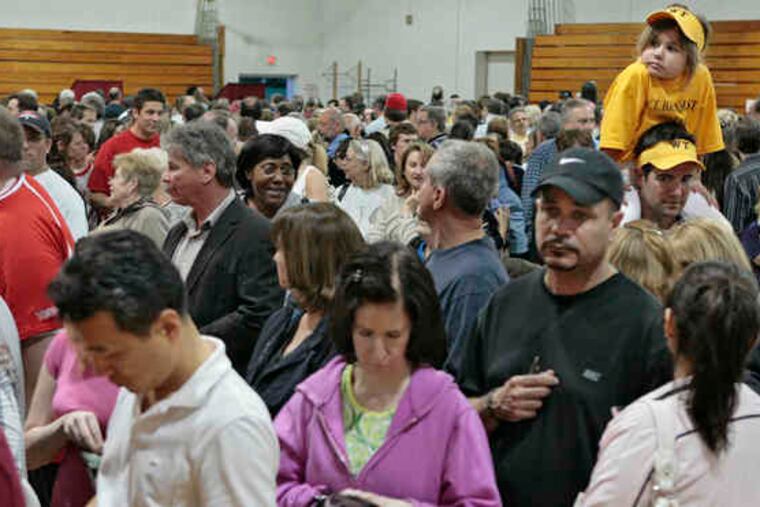 As voters packed the Washington Township High School gymnasium, 6-year-old Ellie Koerner had the best seat in the house - on the shoulders of her father, Dave Koerner - as they waited in line. Turnout was high at other sites, too.