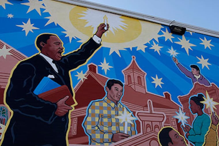 A mural of Martin Luther King on a house next to Calvary Baptist Church. King ministered at the church after graduating from Crozer Theological Seminary. Today, an estimated 70,000 Philadelphians will honor his memory by volunteering a day of service. (Michael S. Wirtz / Staff Photographer)