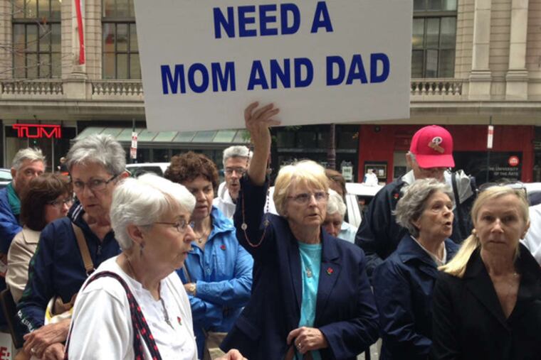 Joan Carbo (center) and protesters at Gov. Corbett's office, attacking his inaction on a judge's overturning of Pa.'s same-sex marriage ban. They sparred with those who disagreed. (Jessica Parks / Staff)