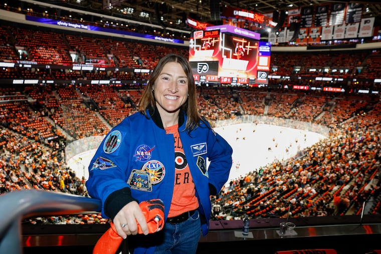 Artemis II astronaut Christina Koch with her rally towel before Flyers Game 4 against the Hurricanes at Xfinity Mobile Arena on Saturday.