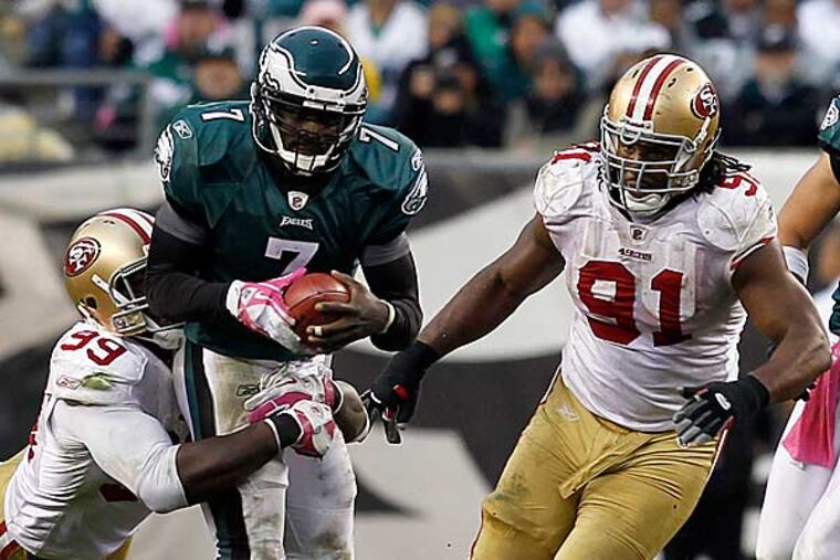Michael Vick (7) is tackled by San Francisco 49ers linebacker Aldon Smith (99) in the second half of an NFL football game Sunday, Oct. 2, 2011 in Philadelphia. (Alex Brandon/AP)