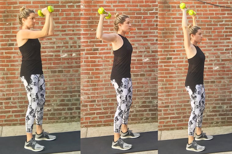 Ashley Greenblatt demonstrates a shoulder press variation.