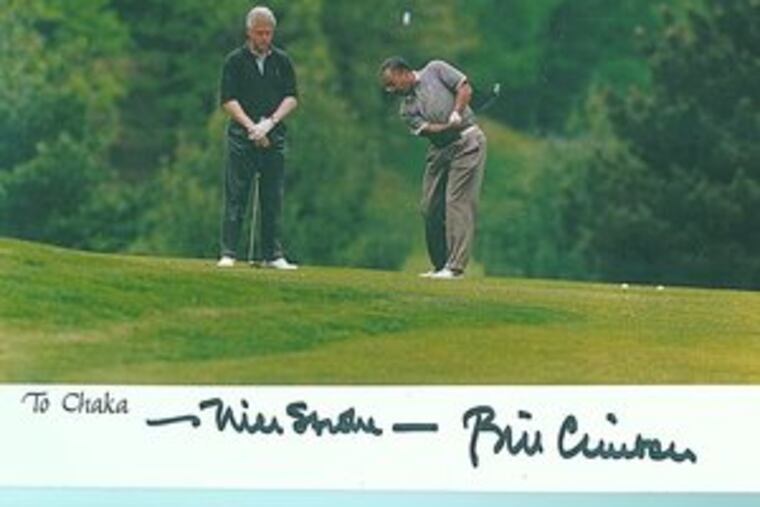 An autographed photo shows Rep. Chaka Fattah golfing with then-President Bill Clinton in Virginia in 1997. Fattah says he hasn't played at all this year and only about 10 times last year.