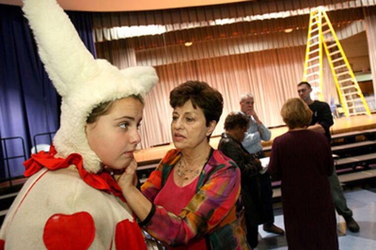 Loretta Wehbe, center, has run the Performing Arts Youth Theatre for 27 years. Wehbe helps Madeleine Procopio with her white rabbit costume. (Charles Fox / Staff Photographer)