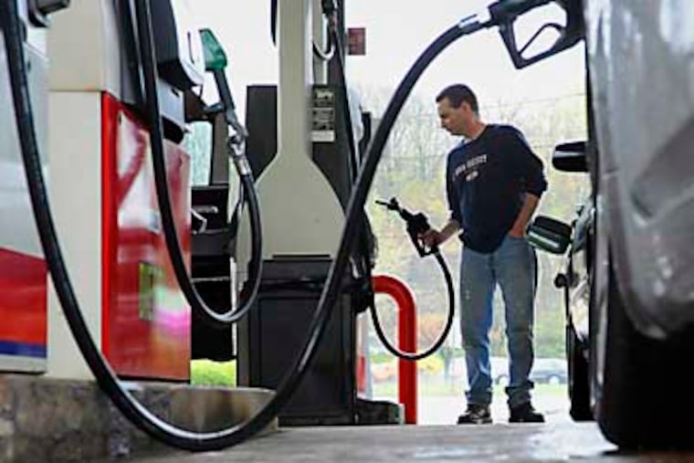 FILE- In this April 28, 2011 file photo, John Magel, of Wetherfield, pumps gas at a station in Wethersfield, Conn. U.S. consumers paid more for gas and food in April, pushing inflation to its highest level in two and a half years. But so far in May 2011, inflationary pressures have begun to ease. (AP Photo/Jessica Hill)