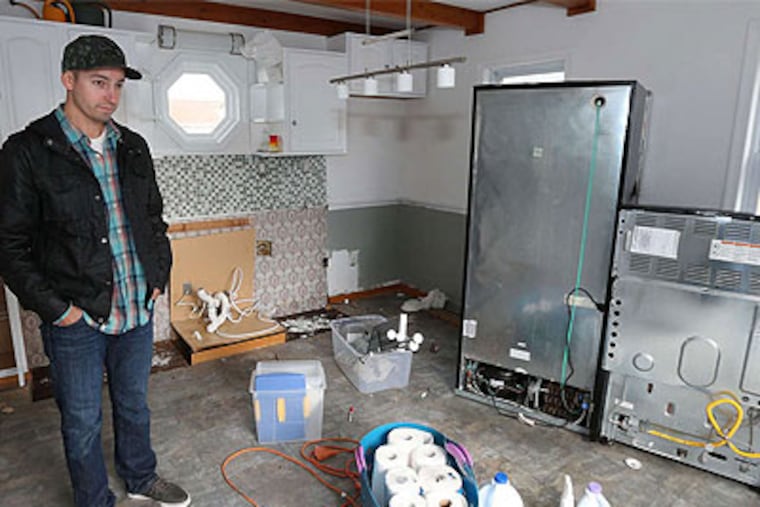 Standing in what was once his kitchen and what soon could be a dance floor, Brigantine Beach resident Kevin McCarty on Tuesday surveys the damage done by Superstorm Sandy three weeks ago. (Tom Briglia / For the Daily News)