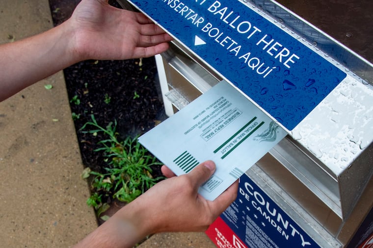 A voter places his ballot in a Camden County ballot drop box for mail ballots, at the Audubon Municipal Building on July 6.