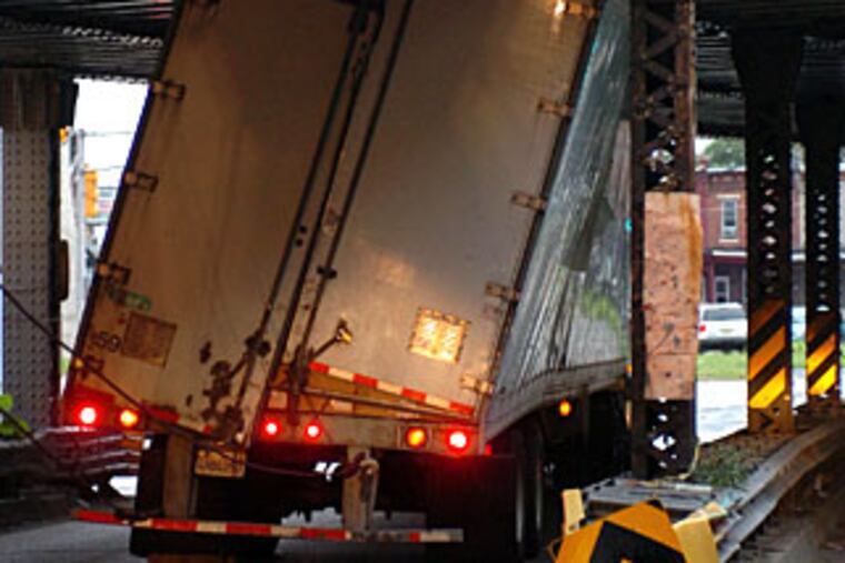 The math came up negative as this 13-foot-plus tractor-trailer rig got stuck underneath the 12-foot, 9-inch train trestle on Haddon Avenue in Camden. The independent trucker from San Bernadino, Calif., was carrying 7,000 pounds of Frito Lay snacks when the accident happened at 3:30 this morning.