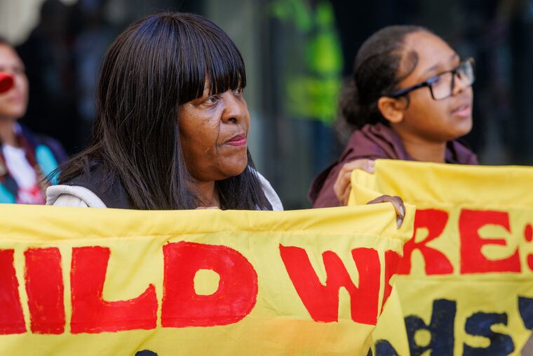 Carolyn Hill (left) marches to protest cuts to SNAP with granddaughter Iadirah Horton. 