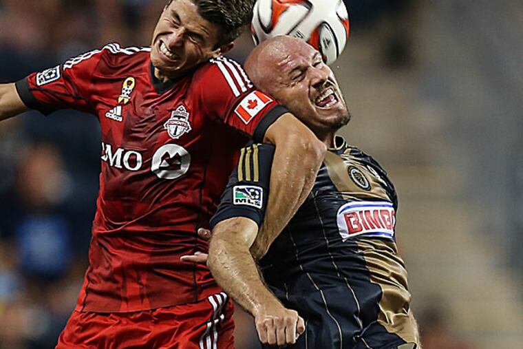 The Union's Conor Casey battles with Toronto FC's Mark Bloom during the first half. (Steven M. Falk/Staff Photographer)