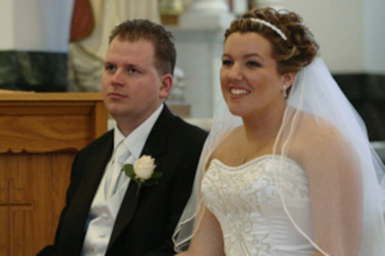 The couple listen to the Rev. Peter Burkauskas during the wedding ceremony at St. Casimir, South Philadel- phia. They met at an after-party for a 5K run and walk.