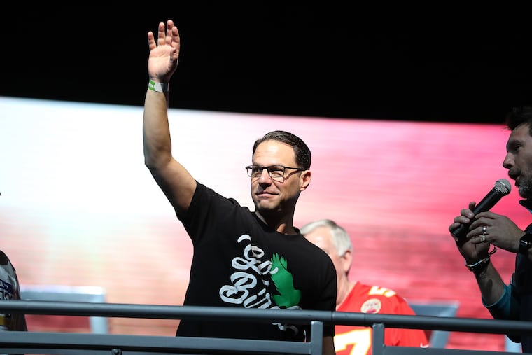 Josh Shapiro, governor of Pennsylvania, waves before meeting with Mike Parson, governor of Missouri, at the NFL Experience to make a friendly wager on the Super Bowl outcome. The governors met at the Lombardi Trophy on Saturday in Phoenix.