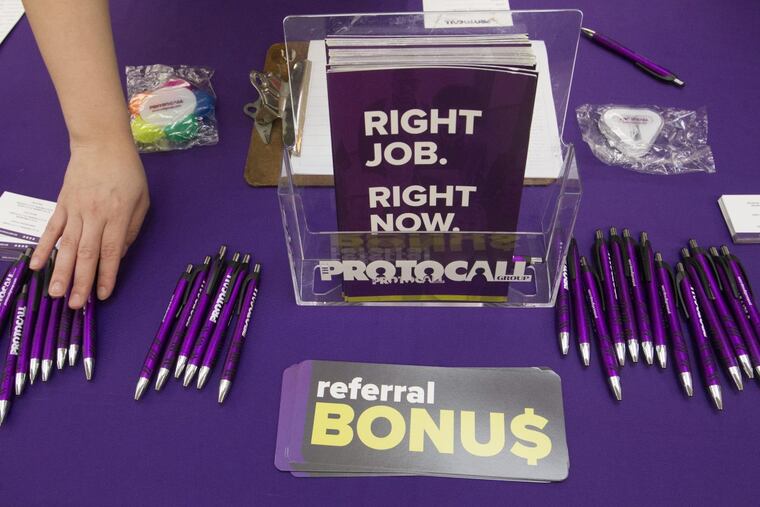 Pam Ranson, recruiter for the Protocol Group Company, arranges her display table during the Recruitment Queen Job Fair inside the Sears court at Oxford Valley Mall in Langhorne, Pa. Wednesday, Jan. 17, 2018.