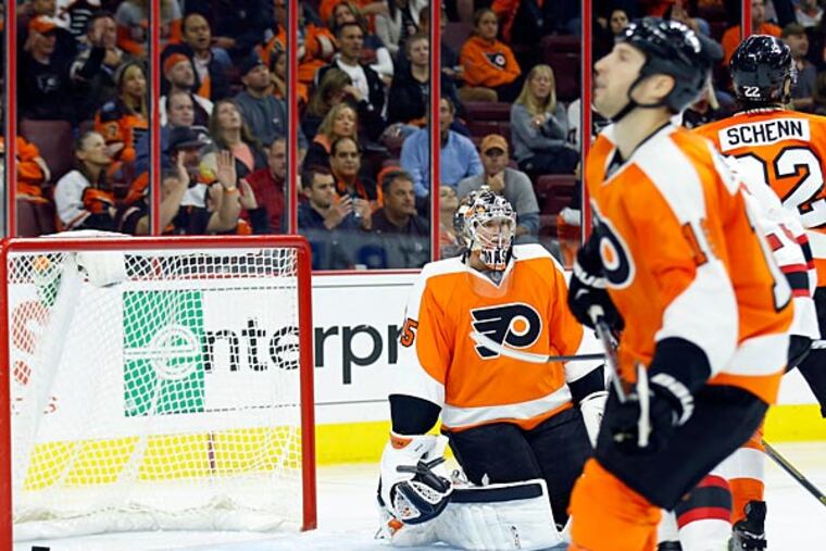Steve Mason sits on the ice as Luke Schenn and R.J. Umberger stand dejected. (Yong Kim/Staff Photographer)