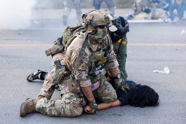 Federal officers hold down a protestor in the Brighton Park neighborhood of Chicago on Saturday, Oct. 4, after protesters learned that U.S. Border Patrol shot a woman Saturday morning on Chicago’s Southwest Side.