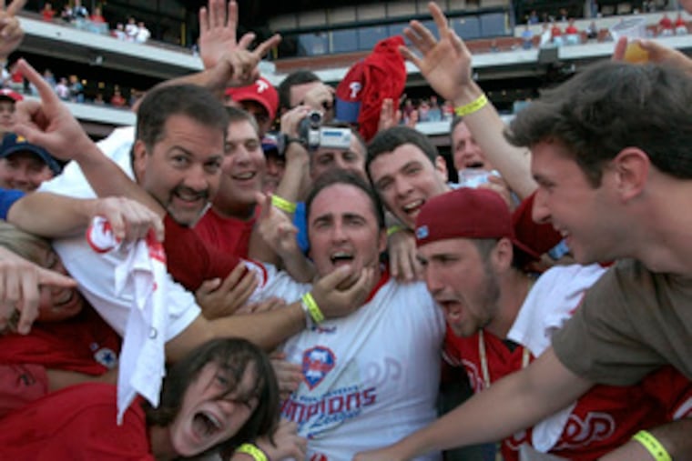 Fans surround Brett Myers (center) to celebrate after the Phillies clinched the National League East crown with a 6-1 win over the Nationals.