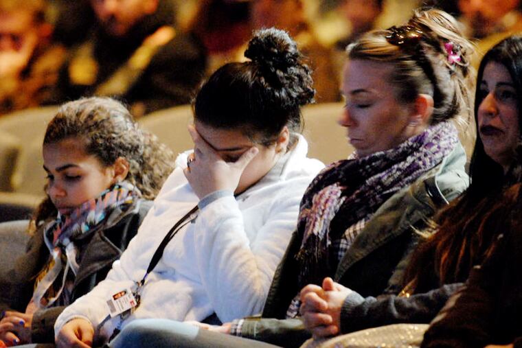 Neighbors and friends of Nicole Stone attend a memorial prayer vigil at the LCBC Church in Harleysville. Stone and five members of her family died at the hands of her ex-husband Monday.