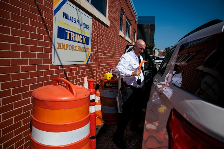 Lt. Brian Geer demonstrates how to use steering wheel locks at the Philadelphia Police Tow Squad.