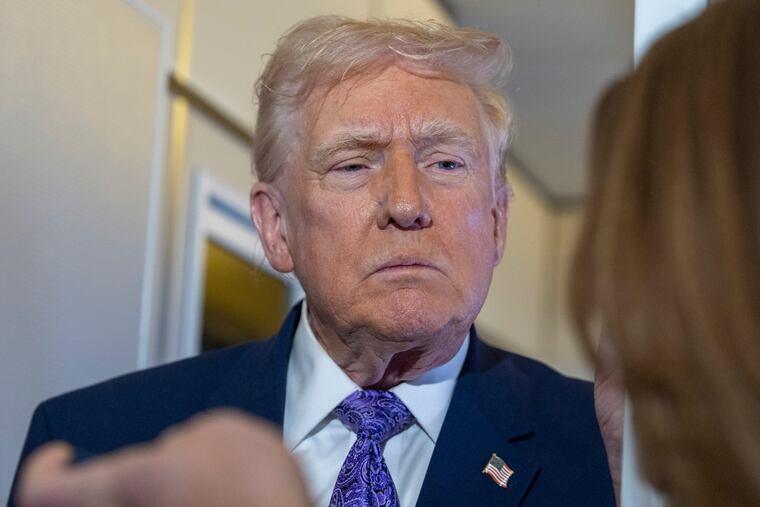 President Donald Trump speaks with reporters while in flight on Air Force One on Sunday, Nov. 30.