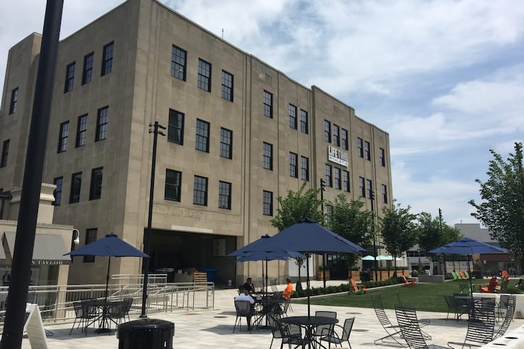 Suburban Square’s four-story flagship, once occupied by Strawbridge & Clothier, is now the home of a lifestyle center offering fitness, coworking, a hair salon, and restaurant.