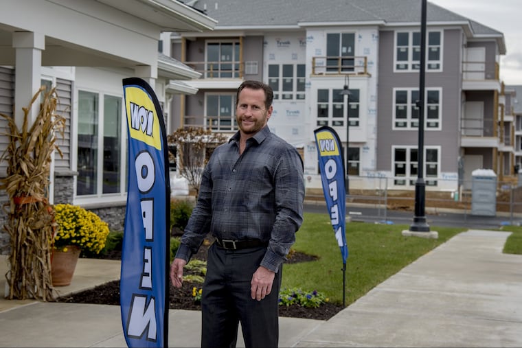 Delco Development President Tom Juliano poses outside Haddon Point Apartments, built on the long-vacant site of the old Pennsauken Mart. TOM GRALISH / Staff Photographer