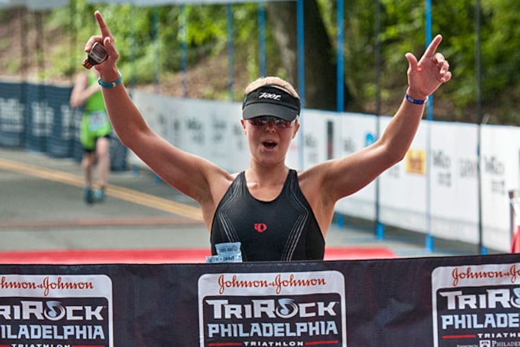 Jordan Verdeur of West Chester crosses the finish in the women's division of the Philadelphia Sprint Triathlon. (Ron Tarver/Staff Photographer)