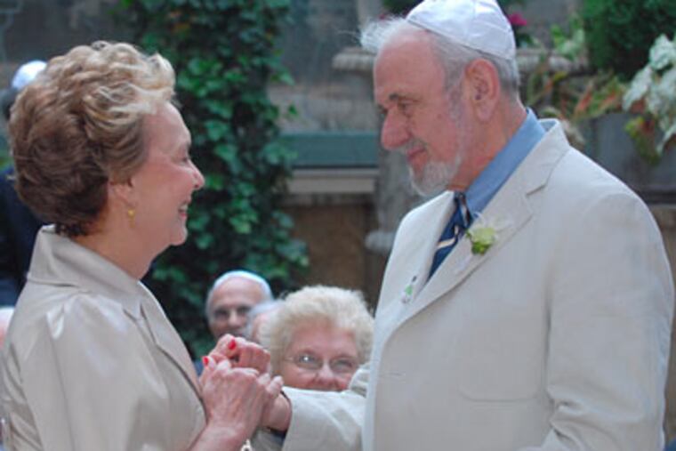The bride and groom are married in the garden of the Rittenhouse Hotel under Harriet's family huppah, which was handmade in Israel and held by Marshall's sons and Harriet's granddaughters.