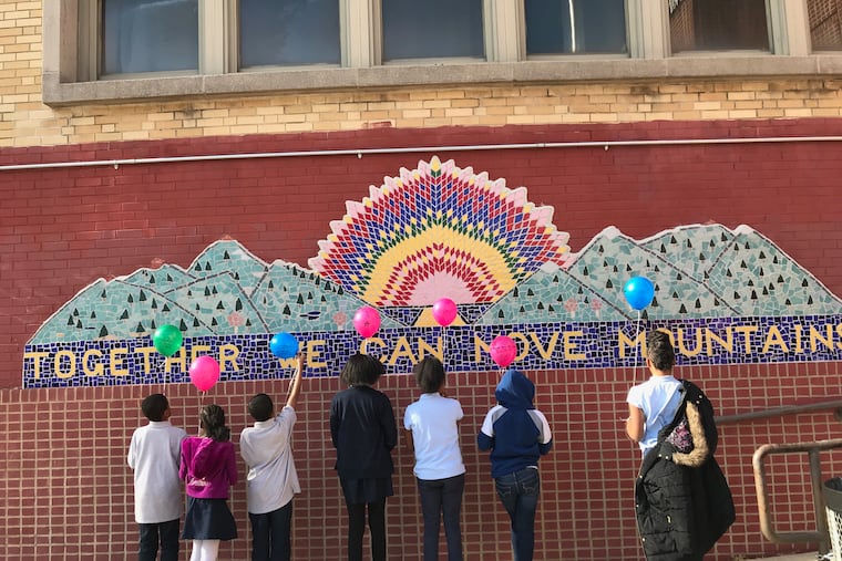 Kids release balloons at the end of a grief group run by Uplift Center for Grieving Children at Franklin S. Edmonds Elementary School, in February 2018.