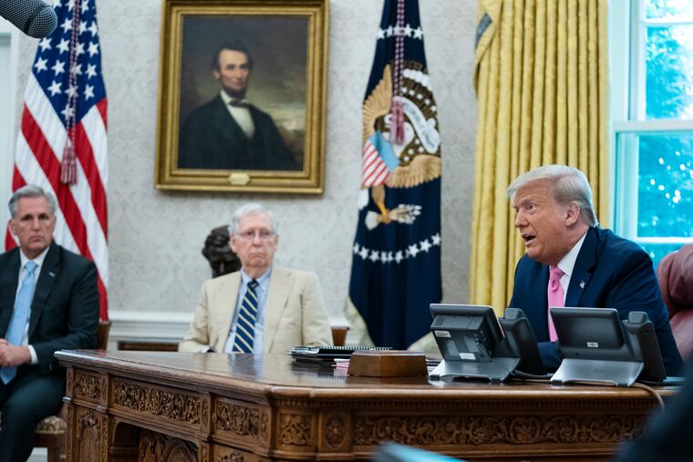 President Donald Trump (right), shown speaking during a meeting with Senate Majority Leader Mitch McConnell of Ky., and House Minority Leader Kevin McCarthy of Calif., in the Oval Office of the White House on Monday.