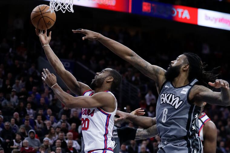 Sixers guard Alec Burks drives past Brooklyn Nets center DeAndre Jordan for a layup during the fourth quarter.
