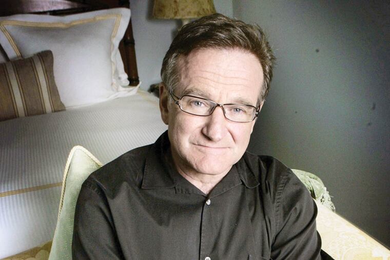 FILE - This June 15, 2007 file photo shows actor and comedian Robin Williams posing for a photo in Santa Monica, Calif. Williams, whose free-form comedy and adept impressions dazzled audiences for decades, died Monday, Aug. 11, 2014, in an apparent suicide. Williams was 63. (AP Photo/Reed Saxon, File)