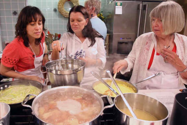 At Reading Terminal Market, Gomez-Rejon cooks with Elaine Charles (center) and Barbara Smetana.