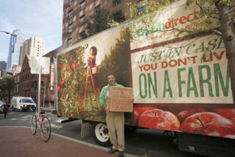 FreshDirect.com driver Cesar Soler delivering fresh-food groceries Monday to a house in Center City. (Michael S. Wirtz / Staff Photographer)
