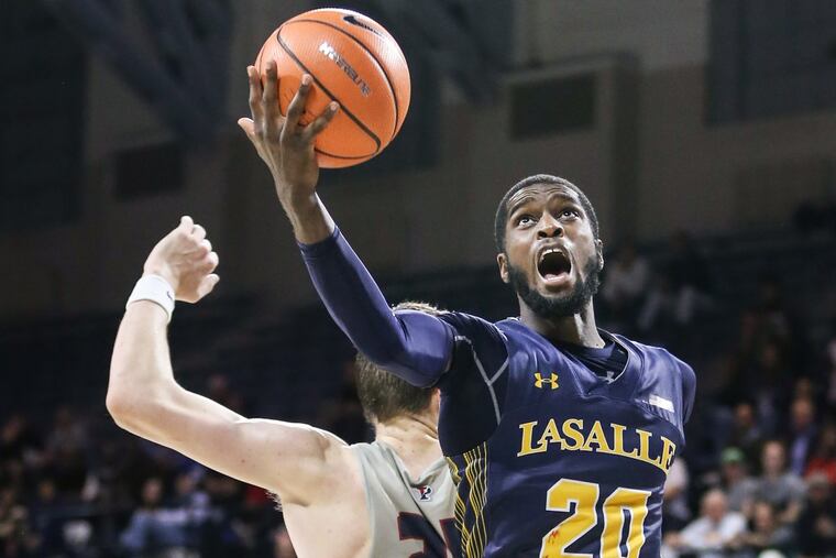 La Salle's B.J. Johnson grabs a loose ball over Penn's AJ Brodeur during the first overtime Monday night.