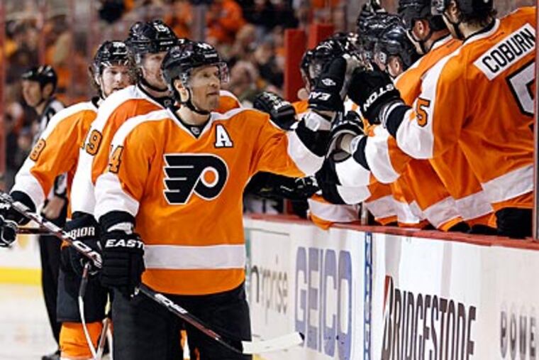 Flyers' Kimmo Timonen celebrates his third period goal with his teammates. (Yong Kim/Staff Photographer)