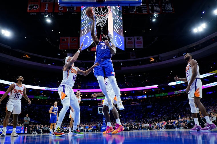 Philadelphia 76ers' Joel Embiid (21) goes up for a shot against Phoenix Suns' Damion Lee (10) during the second half of an NBA basketball game, Monday, Nov. 7, 2022, in Philadelphia.